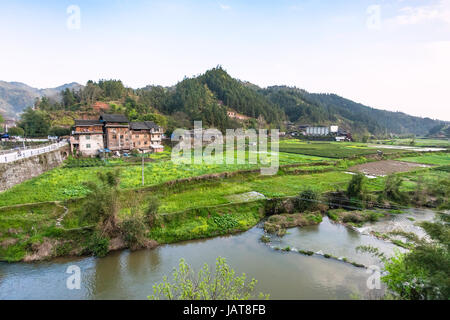 travel to China - view of gardens, rice paddy, tea plantation near river in Chengyang village of Sanjiang Dong Autonomous County in spring season Stock Photo
