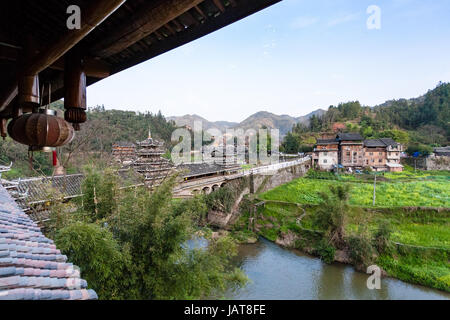 travel to China - view of Wind and Rain Bridge and gardens near river in Chengyang village of Sanjiang Dong Autonomous County in spring season Stock Photo