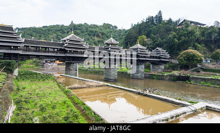 travel to China - irrigation canal and Chengyang Wind and Rain Bridge (Fengyu, Yongji or Panlong Bridge) in Sanjiang Dong Autonomous County in spring  Stock Photo