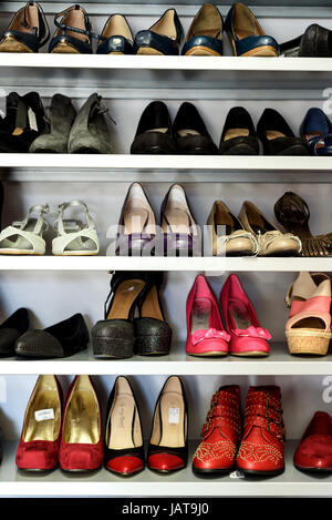 Rows of womens second hand shoes and heels in a vertical composition Stock Photo