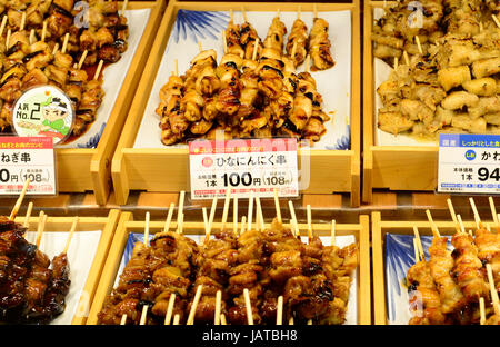 Yakitori and other Japanese grilled meat on skewers on display in a ...