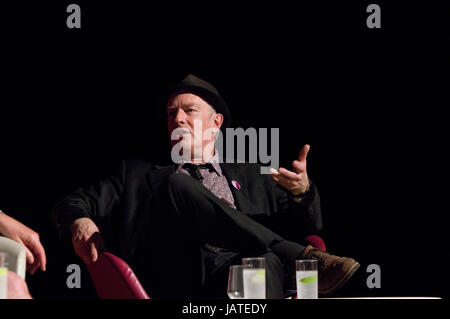 Cartoonist and writer Martin Ronson on stage in June 2017 at the 8th annual Stoke Newington Literary Festival against a black background. Stock Photo