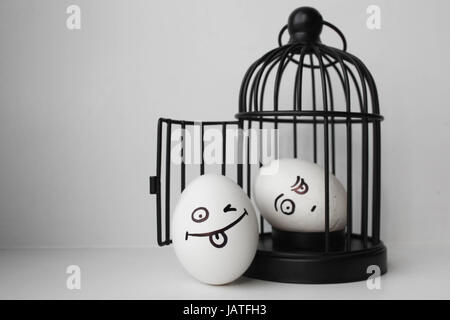 Eggs with painted face. Photo for your design. two eggs. Overseer and criminal. jail Stock Photo