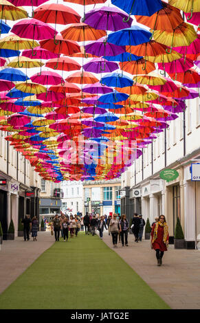 Umbrellas suspended in the air above shoppers in Southgate Shopping Centre, Bath, England, UK Stock Photo