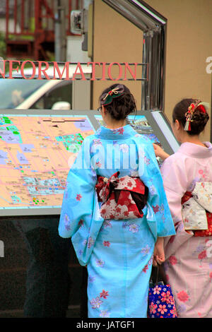 Old Japanese lady in kimono crossing street in front of Asakusa Culture ...