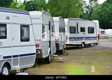 New touring caravans parked in a row on a caravan trade park Stock Photo