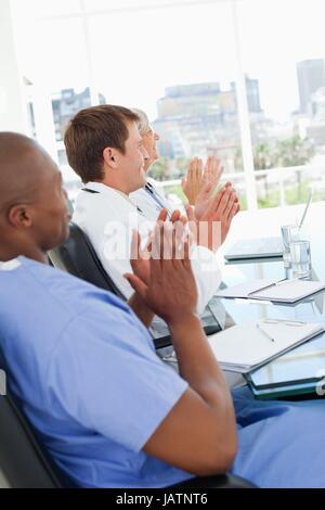 Side view of applauding doctors Stock Photo