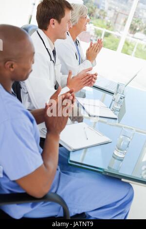 Side view of clapping doctors Stock Photo