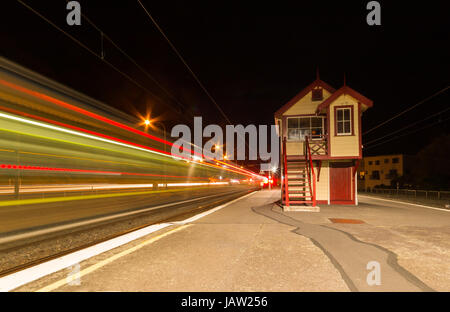 The Paekakariki signal box at night with a epress train zooming pass. Stock Photo