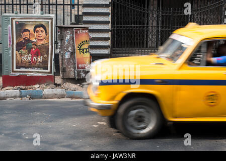 An iconic yellow taxi drives down a road in Kolkata (Calcutta), West Bengal, India Iconic yellow taxi drives down a road in Kolkata (Calcutta), West B Stock Photo