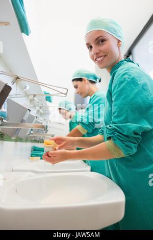 Close up of surgeons brushing hands Stock Photo