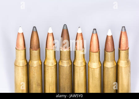 Tips of a few rifle bullets lined up in a row on white background Stock ...