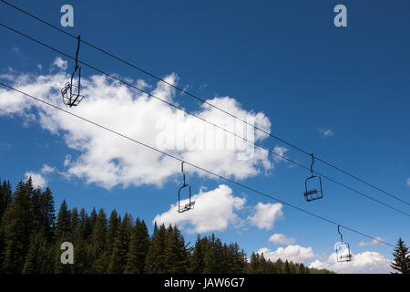 Empty ski lift seats from below Stock Photo