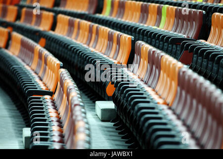 Rows of empty seats of different colors in a stadium Stock Photo