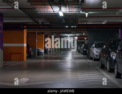 Parking garage, underground interior with a few parked cars Stock Photo