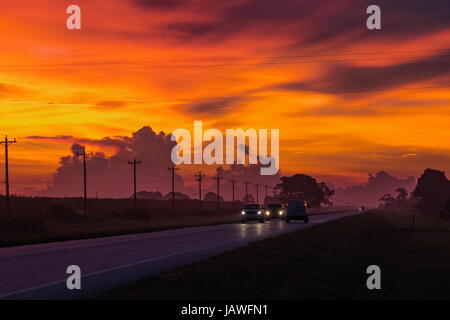 Sunrise clouds against a roadway in Lee county, Florida. Stock Photo