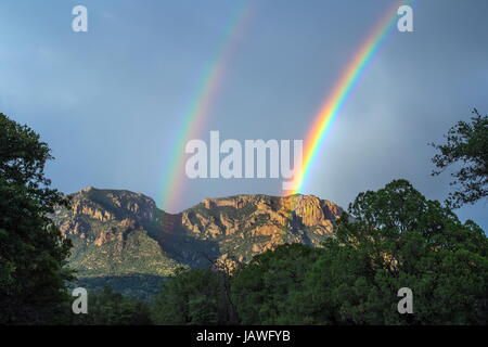 A rainbow arches above the Chiricahua mountains in southeastern Arizona. Stock Photo