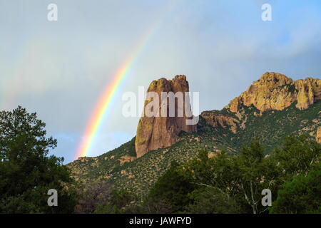 A rainbow arches over the Chiricahua mountains in southeastern Arizona. Stock Photo