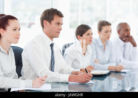 Salespeople sitting in a meeting Stock Photo