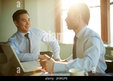 Portrait of smart businessmen discussing new ideas at meeting Stock Photo