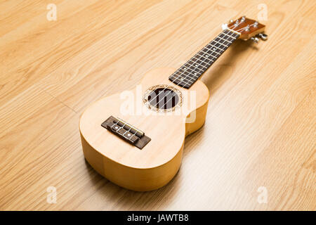 Ukulele over the wooden background Stock Photo