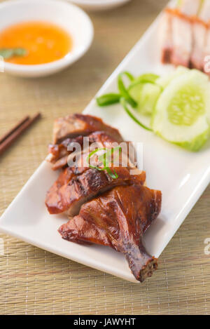 Roasted duck, Chinese style, served with steamed rice on dining table. Singapore cuisine. Stock Photo