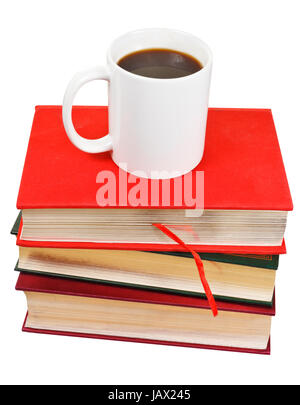 white mug of coffee on stack of books isolated on white background Stock Photo