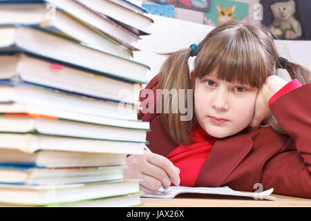 Schoolgirl doing written exercises in school notebooks Stock Photo