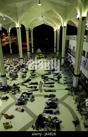 Homeless people sleep at Kamlapur Railway Station at night. Dhaka, Bangladesh. Stock Photo