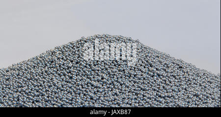 pile of silver metallic beadlets in light grey back Stock Photo