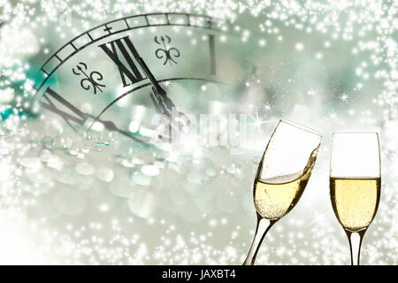 Glasses with champagne against fireworks and clock close to midnight Stock Photo
