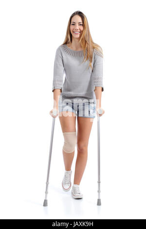 Front view of a woman walking with crutches isolated on a white background Stock Photo