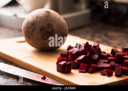 Chopped and whole beetroot on cutting board. Stock Photo
