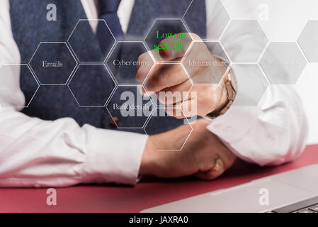 Concept image of Businessman sitting at desk pushing virtual button on screen saying log on securely.