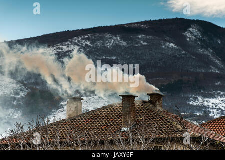 Chimney of the house and smok. Mountain view Stock Photo