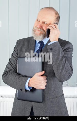 Picture of a confident businessman having a phone call Stock Photo
