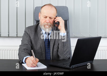 Picture of a thoughtful employer having a phone call Stock Photo
