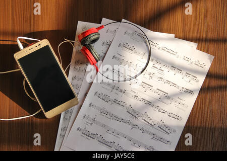 Top view mobile phone, headphone and musical notes Stock Photo