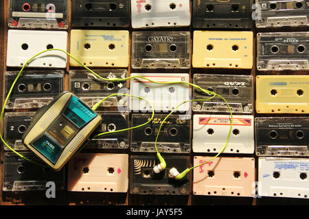 Top view of audio cassettes arranged in rows and columns with cassette player Stock Photo