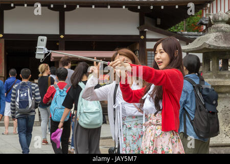 Young Chinese girls taking selfie at Kiyomizu-dera temple area in Kyoto, Japan. Stock Photo