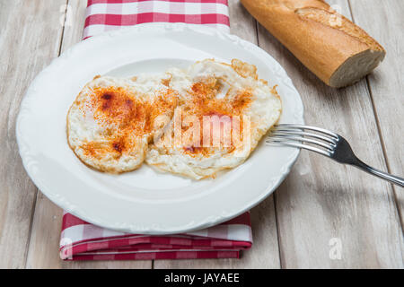 A dish of fried eggs with bread Stock Photo
