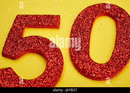 Number fifty red color over a yellow background. Anniversary. Horizontal Stock Photo