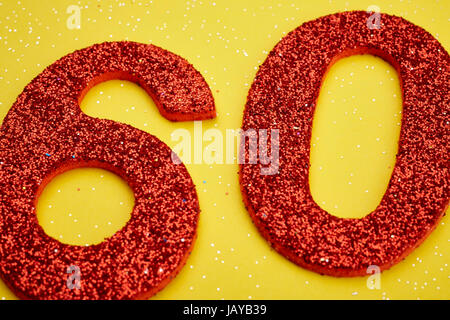 Number sixty red color over a yellow background. Anniversary. Horizontal Stock Photo