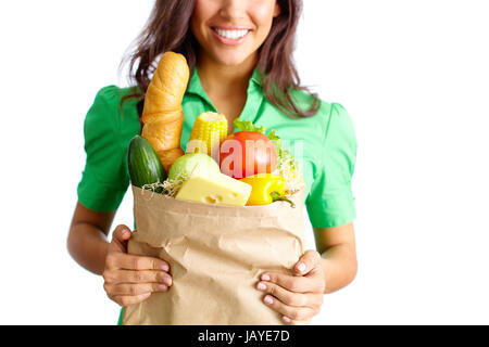 Image of paper packet full of different kinds of food held by female Stock Photo