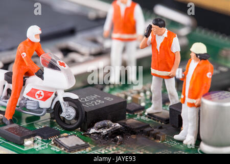 miniature workers on a computer mainboard - studio shot Stock Photo