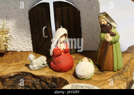 nativity scene with the holy family with a small ceramic sheep Stock Photo