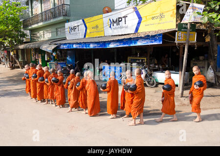 Monks collecting donations of food, Pakokku, Myanmar Stock Photo