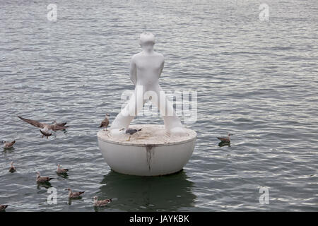 White buoy shaped like man in Port Vell, Barcelona, Spain Stock Photo