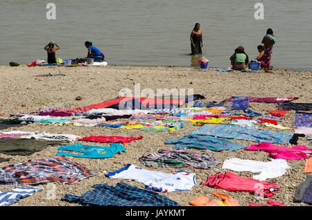 People washing and drying clothes in Ayerwady River, Mingun, Mandalay, Myanmar Stock Photo