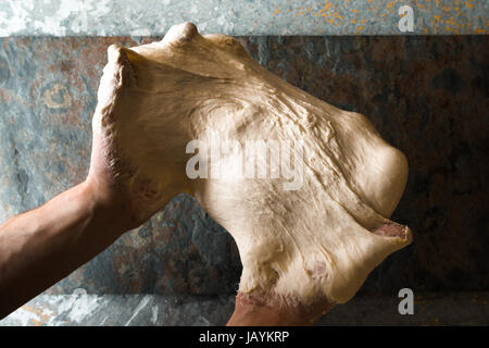 Male hands preparing dough for pizza on table closeup horizontal Stock Photo